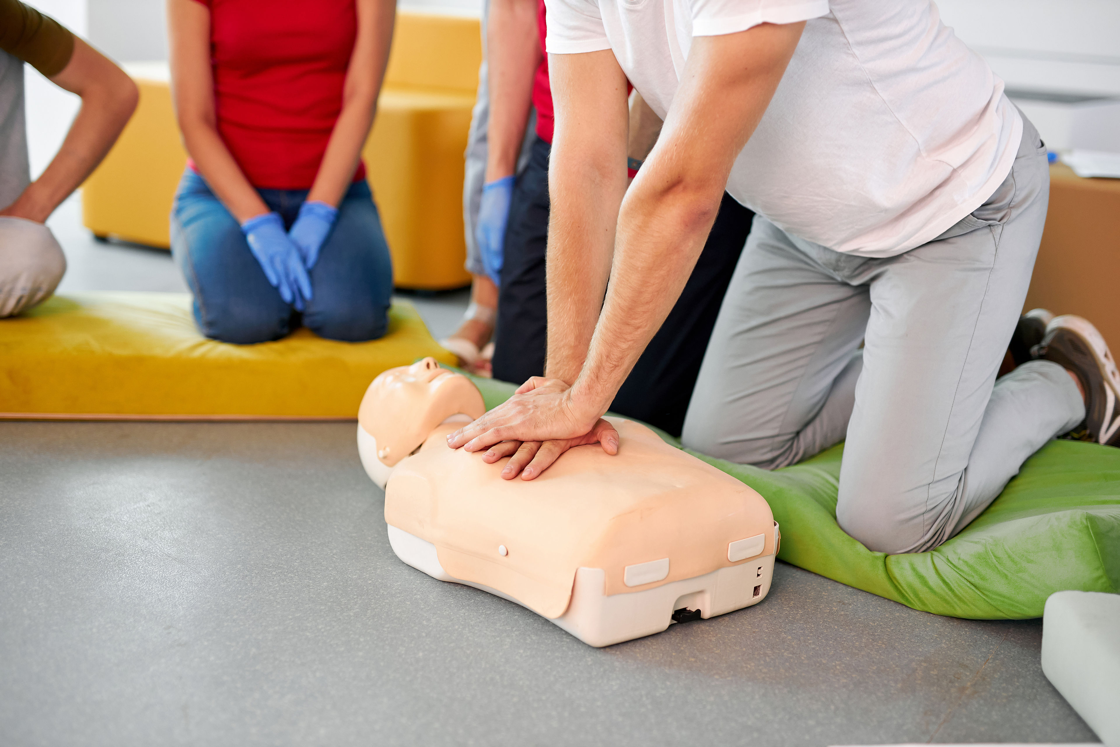 caucasian people practice an exercise of resuscitation